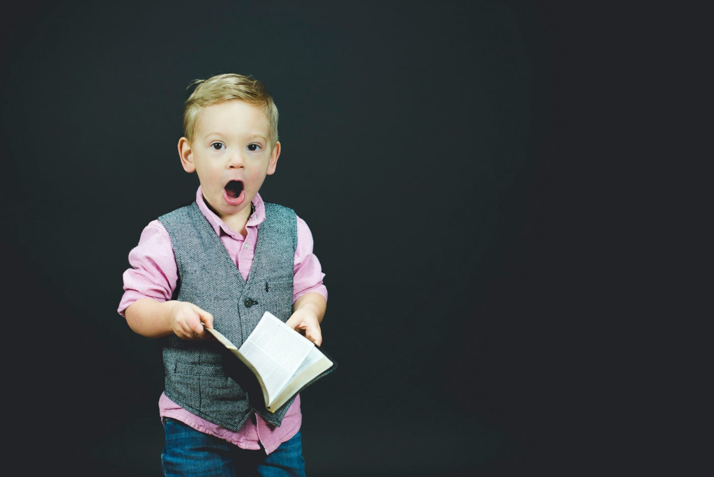 A well-groomed child holding a book