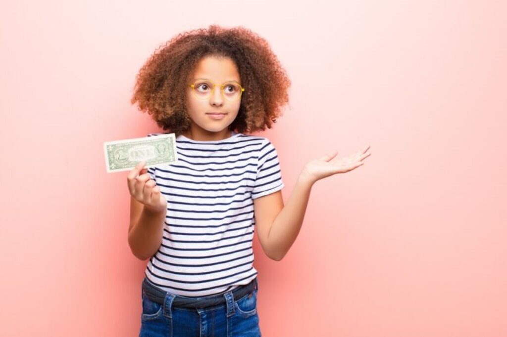 A young girl holding a brown leather wallet