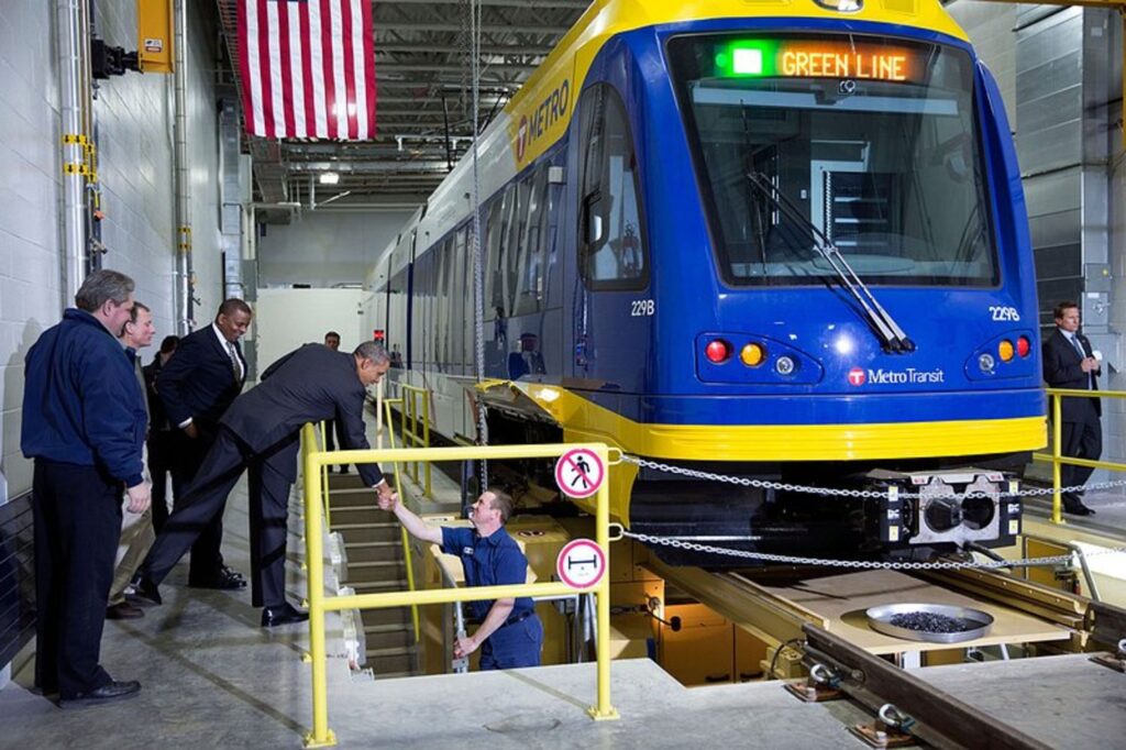 President Barack Obama shakes hands with an employee