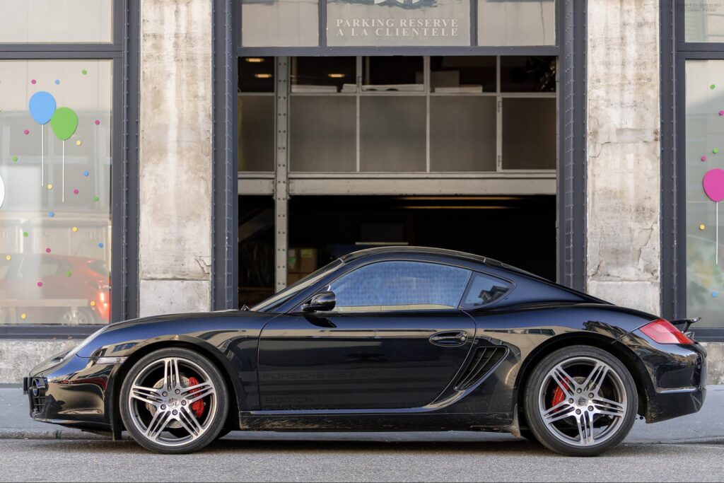 Black sports car parked out front