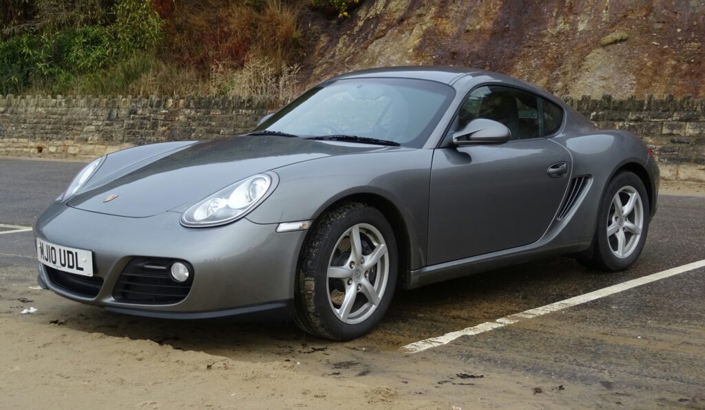 A Porsche car in a parking lot 