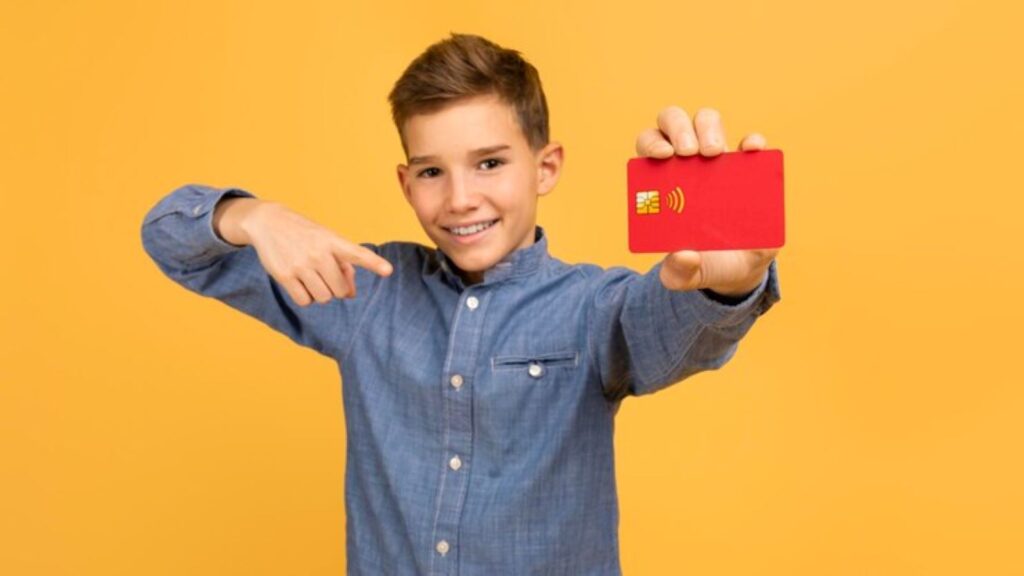 A young kid flashing his ATM card