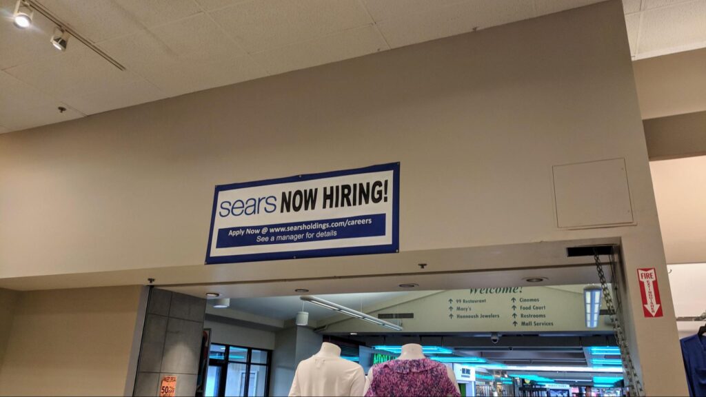 A Sears outlet with a hiring sign out front