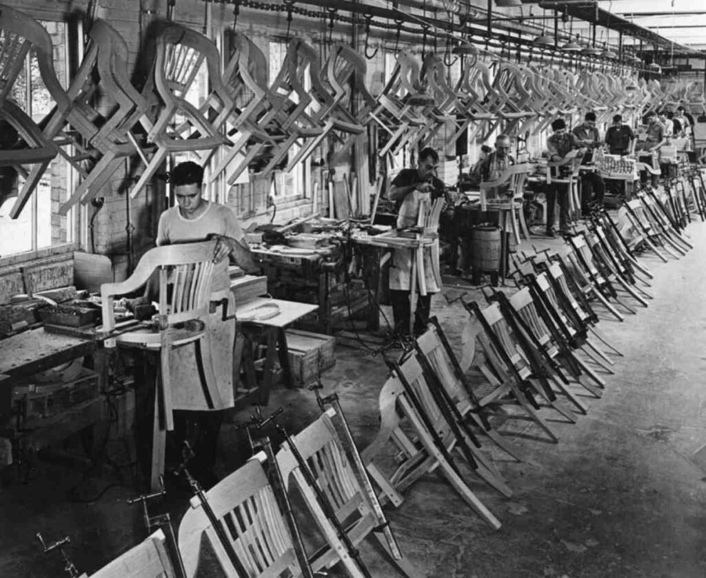 Chair backs are being glued together in this chair factory