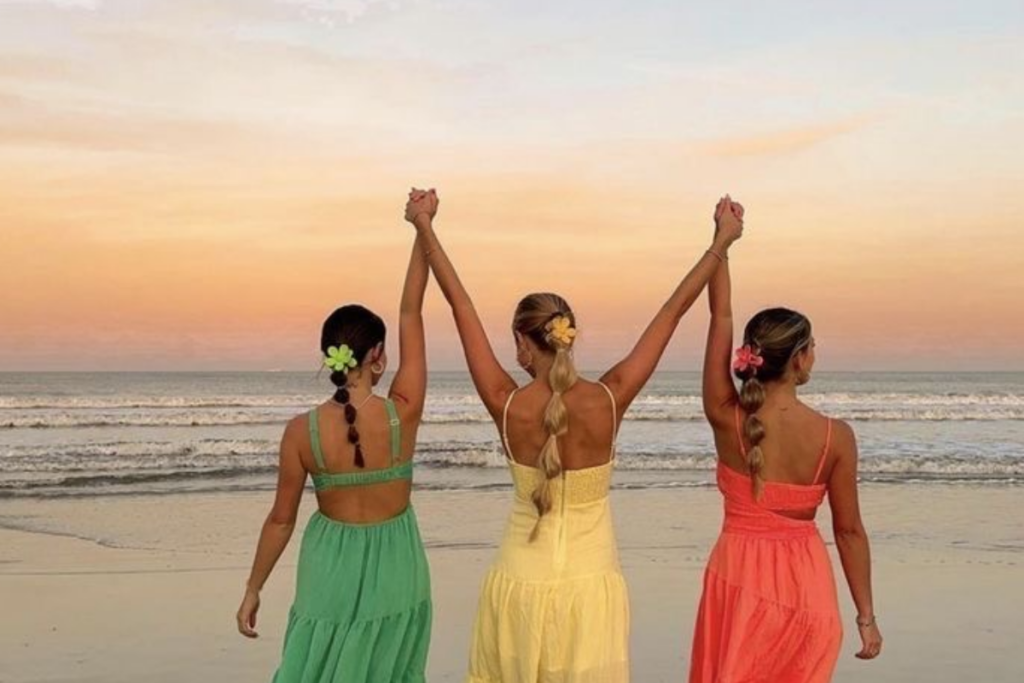 Girls' holding hands at a beach