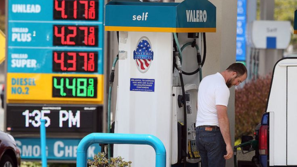 A man filling his gas at the station