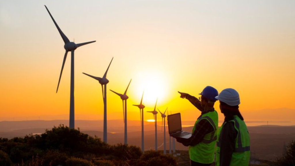 Man points at wind turbine