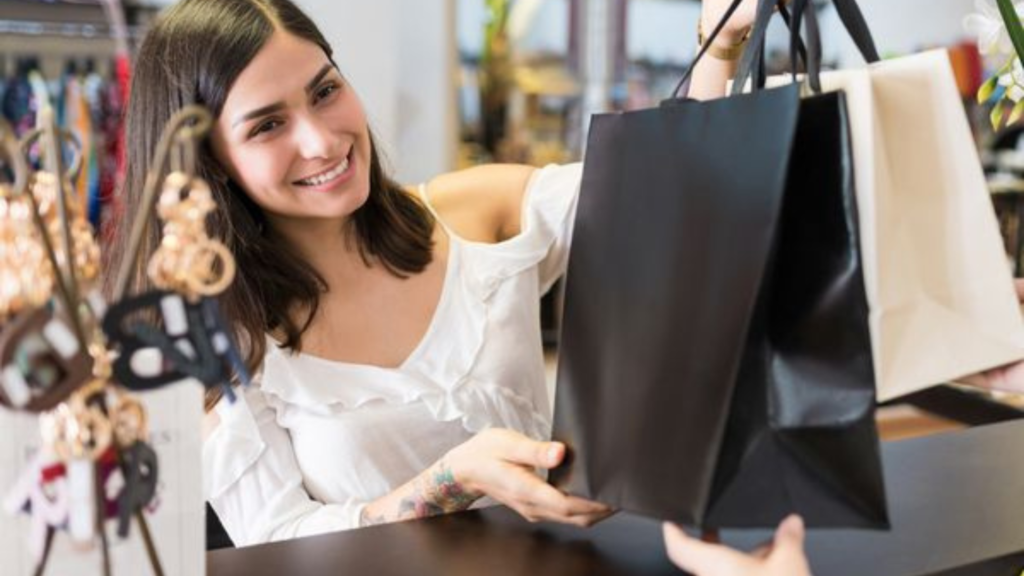 A customer collecting bags of shopped items