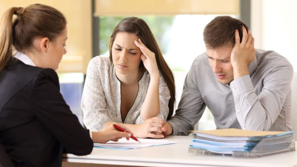 A sad couple looking at a document