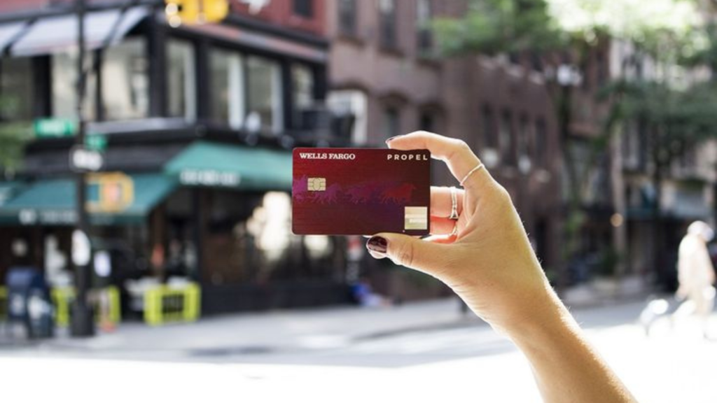 Woman holding a Well Fargo Credit Card