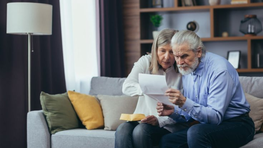 Boomer couple sitting and reading a document