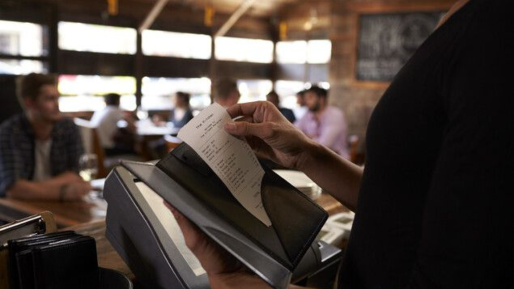 Waiter holding a receipt