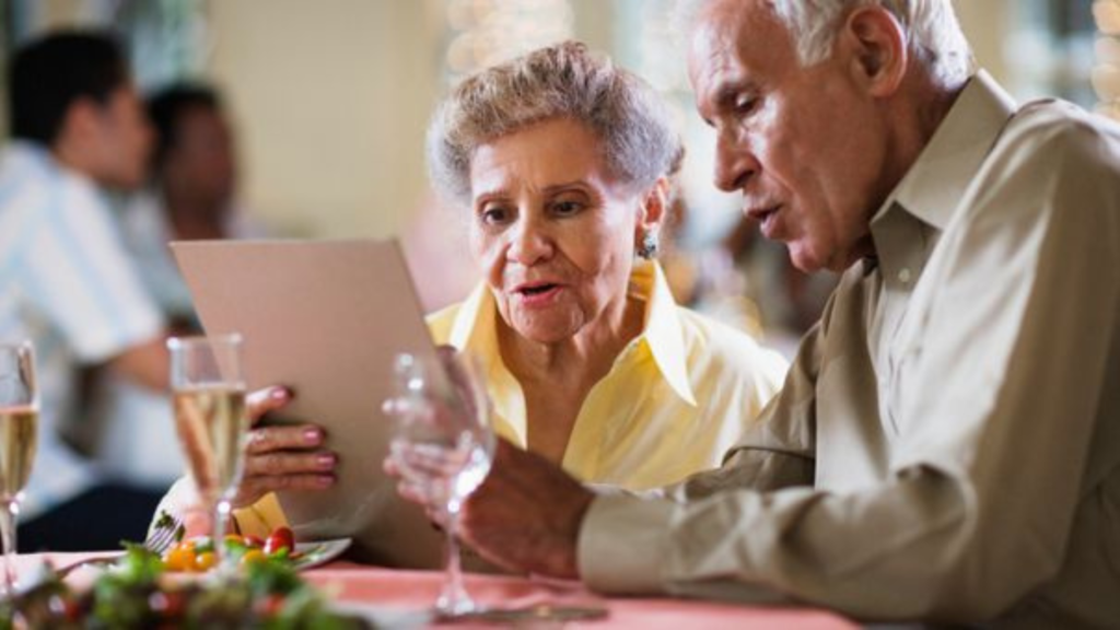 Old couple looking at a menu