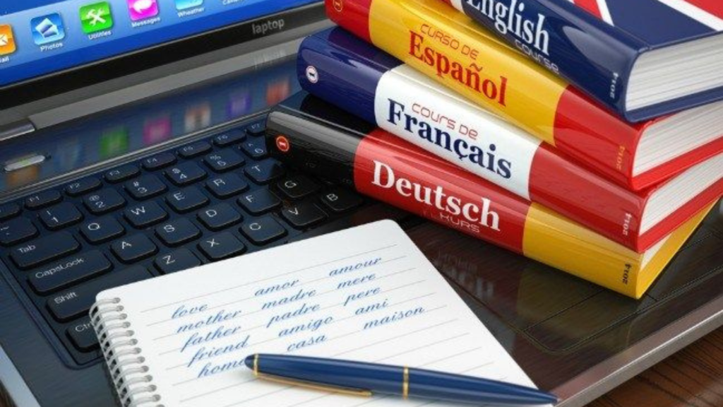 A stack of books on a table with a notepad and pen