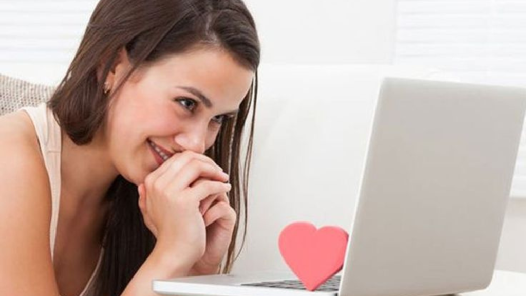 Woman smiling at her laptop screen