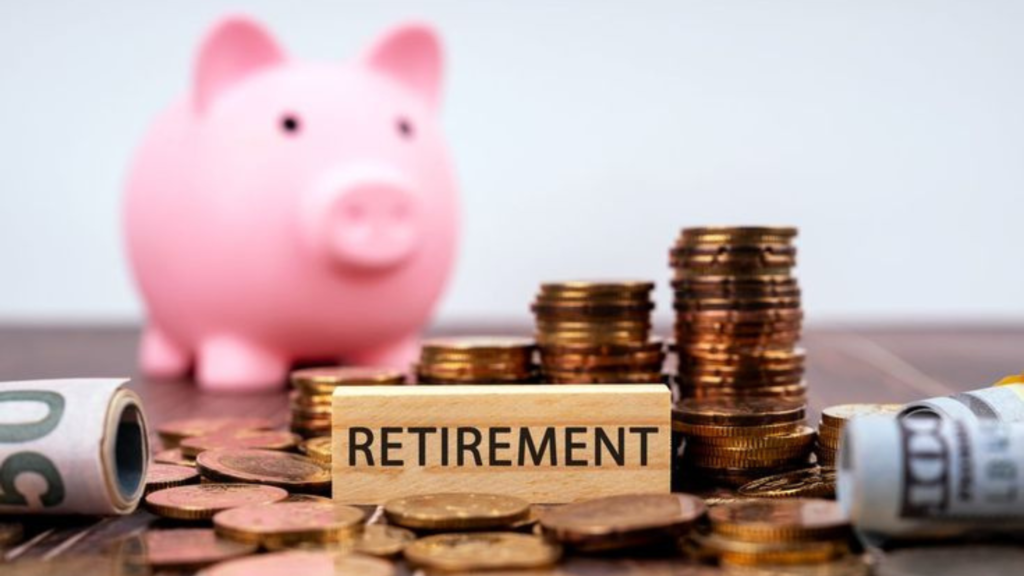 Retirement written on a bar, by a piggy bank with stacks of coins on the table