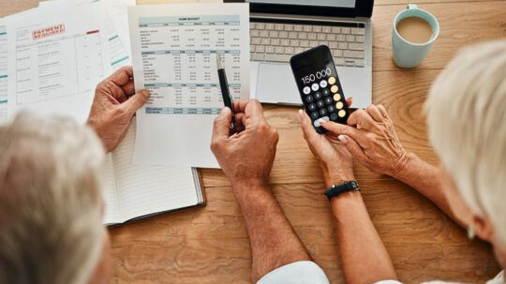 Couple holding a document and phone calculator