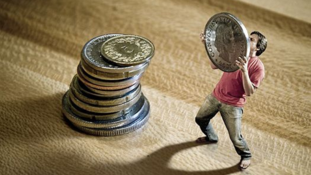 A man carrying a coin to place it on a stack