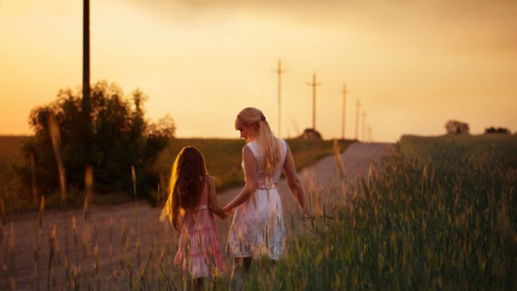 Mother and daughter walking down the road