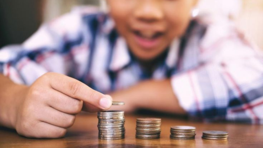 A boy arranging coins in a stack