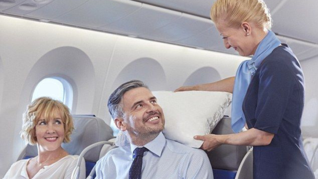 Flight attendant making passenger comfortable