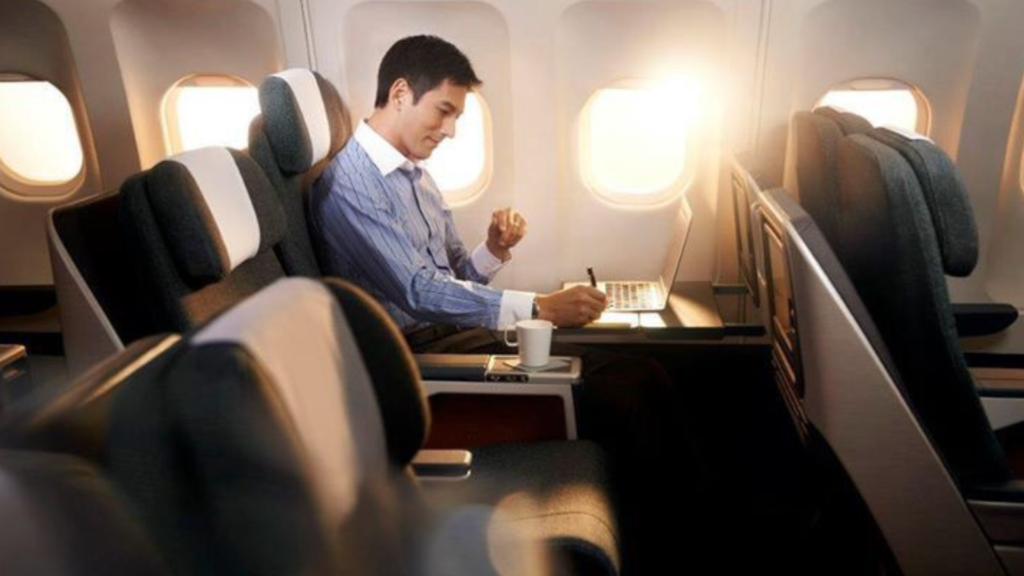 Man writing on a notepad on a plane