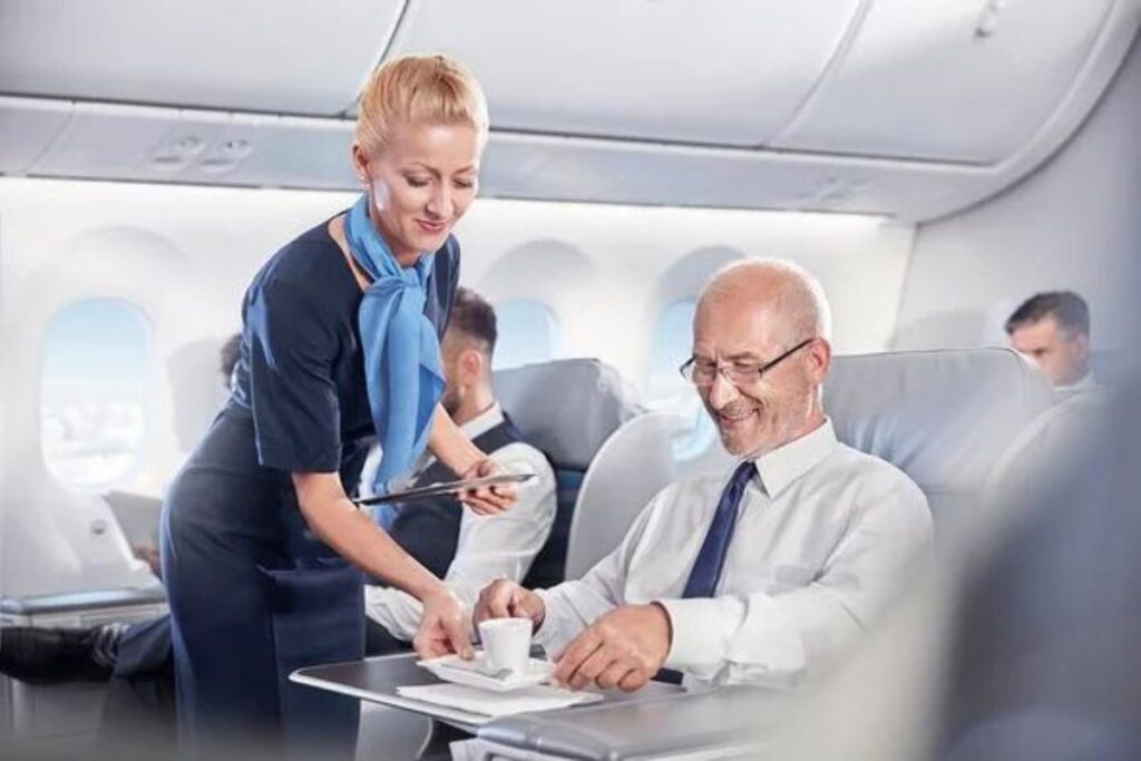 Flight attendant serving passenger