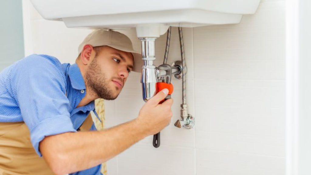 Plumber fixing a sink