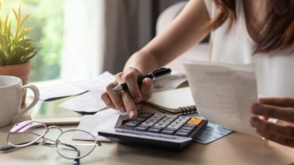 Woman making calculations on calculator