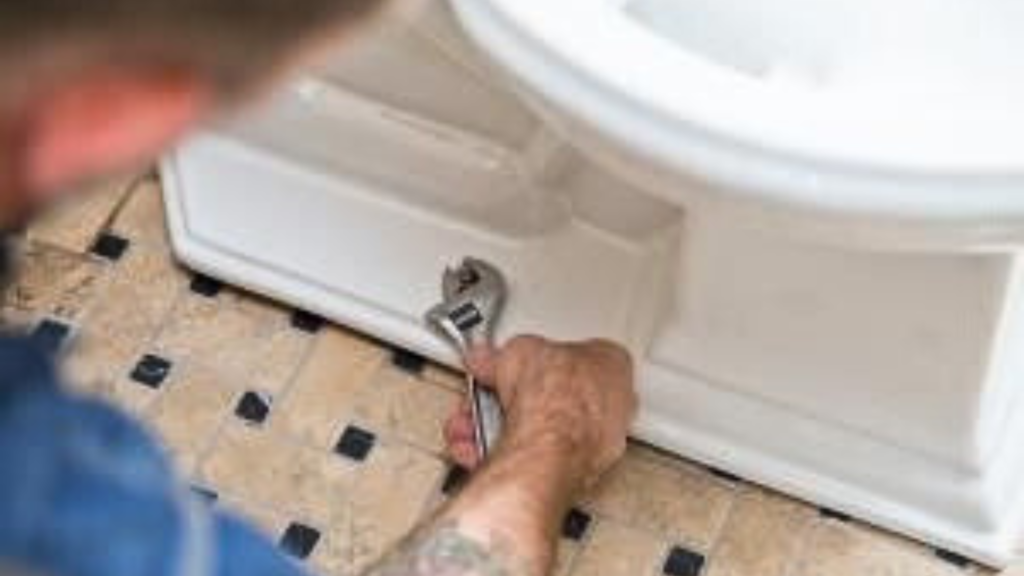 Plumber installing a toilet