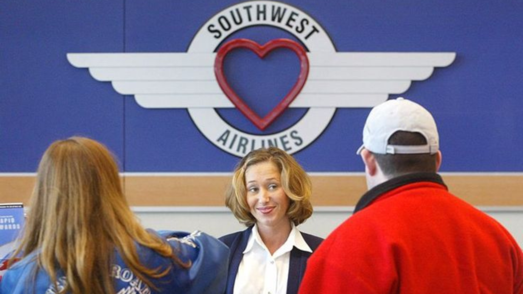 A customer service representative at Southwest Airlines with customers