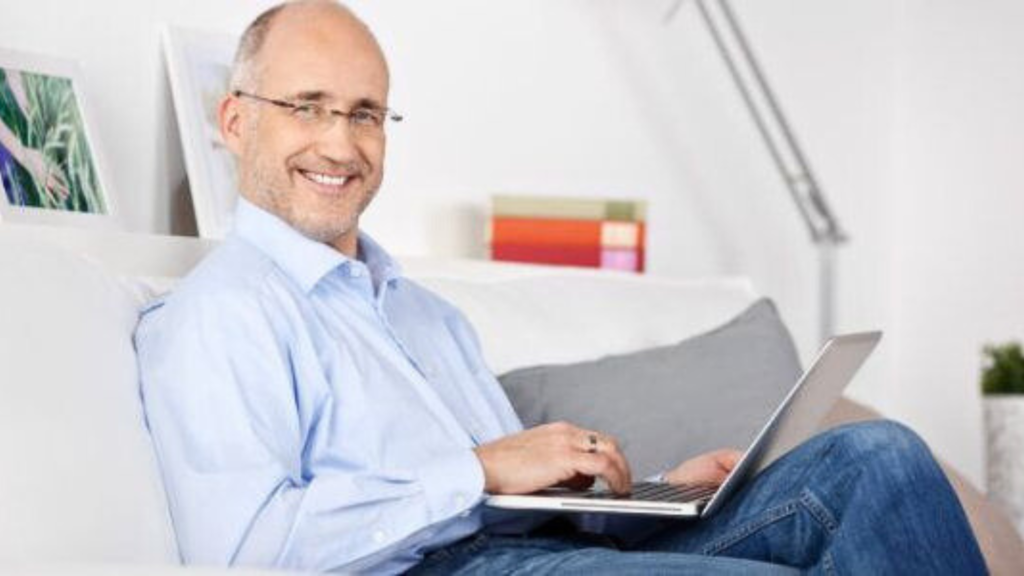 An elderly man with laptop