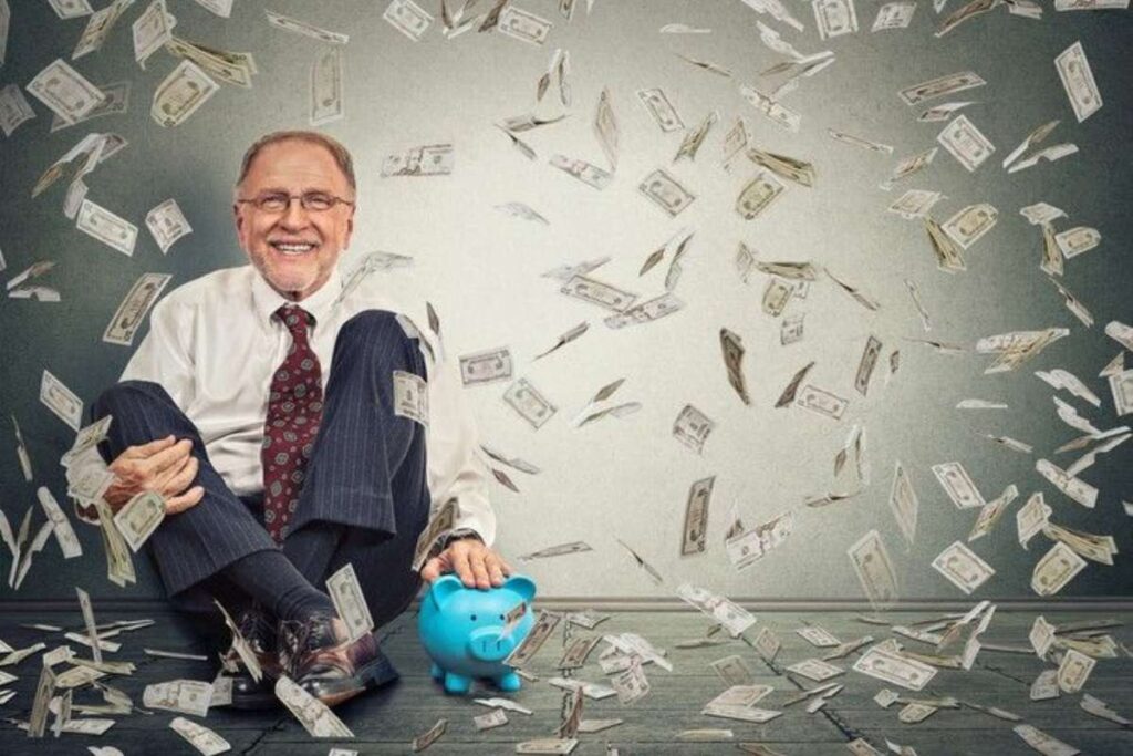 An elderly man holding a piggy bank