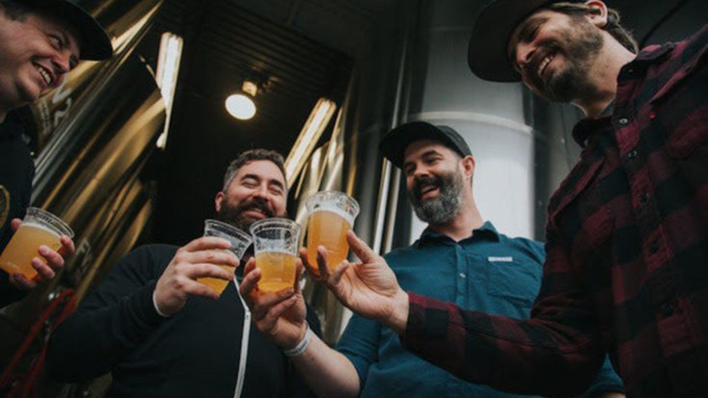 Men cheering with cups of beer