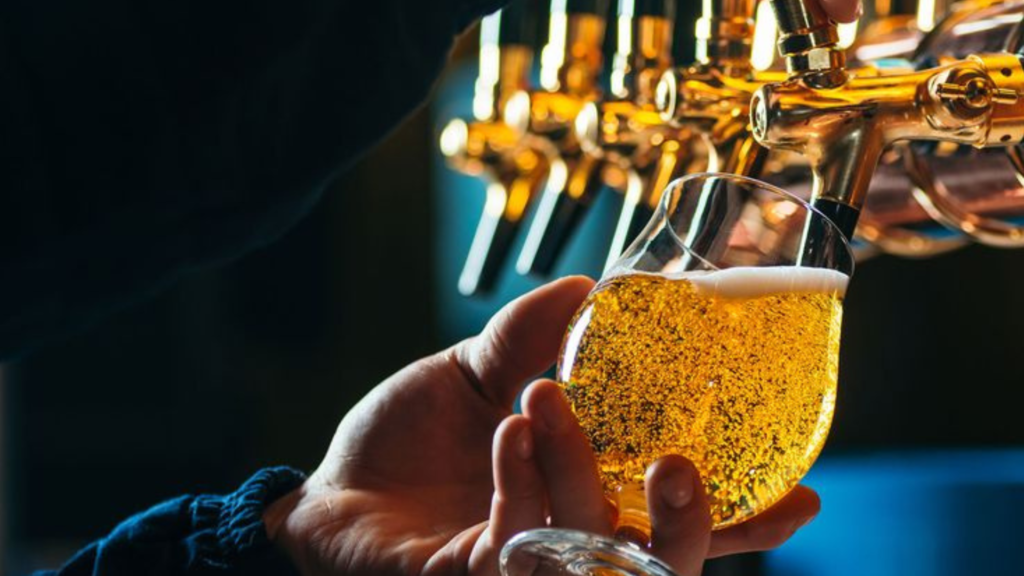 Filling beer in a glass cup