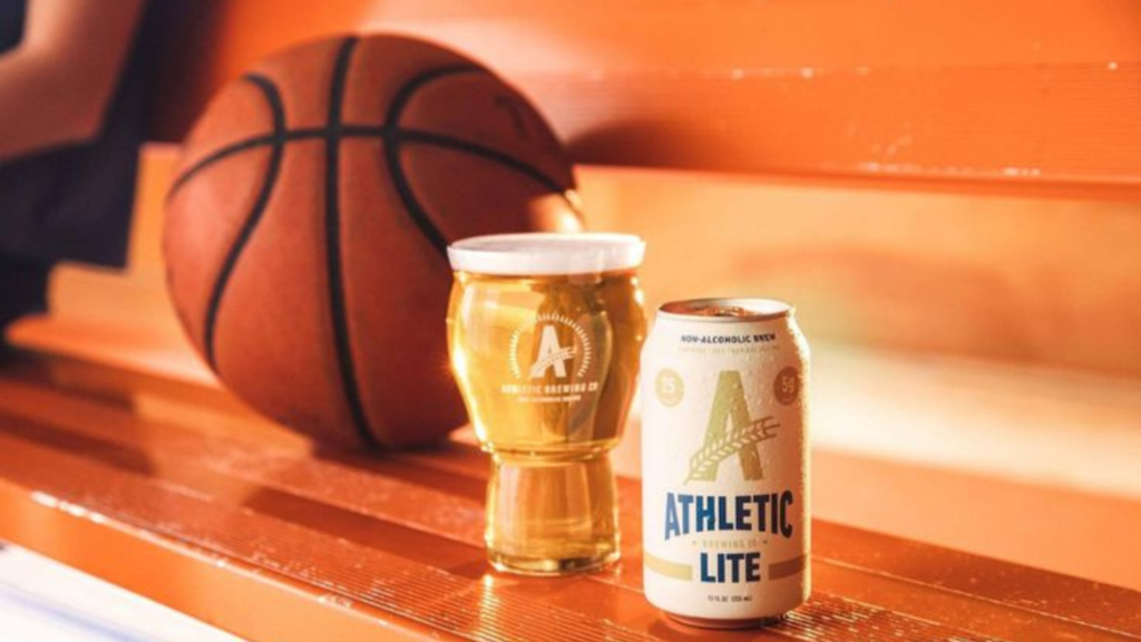 A can and glass of athletic beer with a basketball on a bench