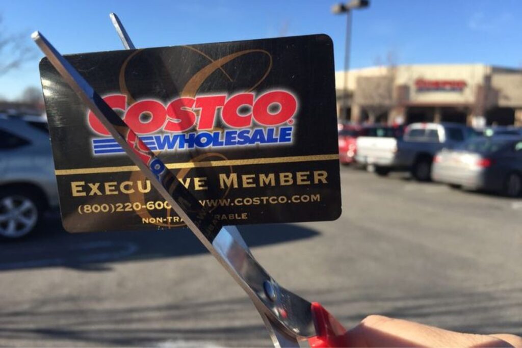 Cutting a Costco membership card with scissors