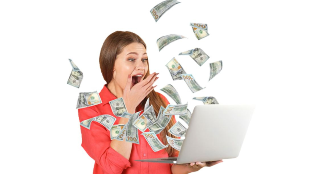 A woman holding a laptop with cash flying in the air