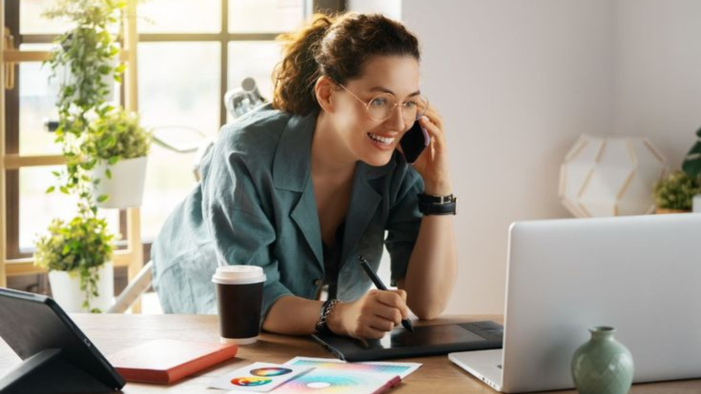 A lady on the phone and holding a pen