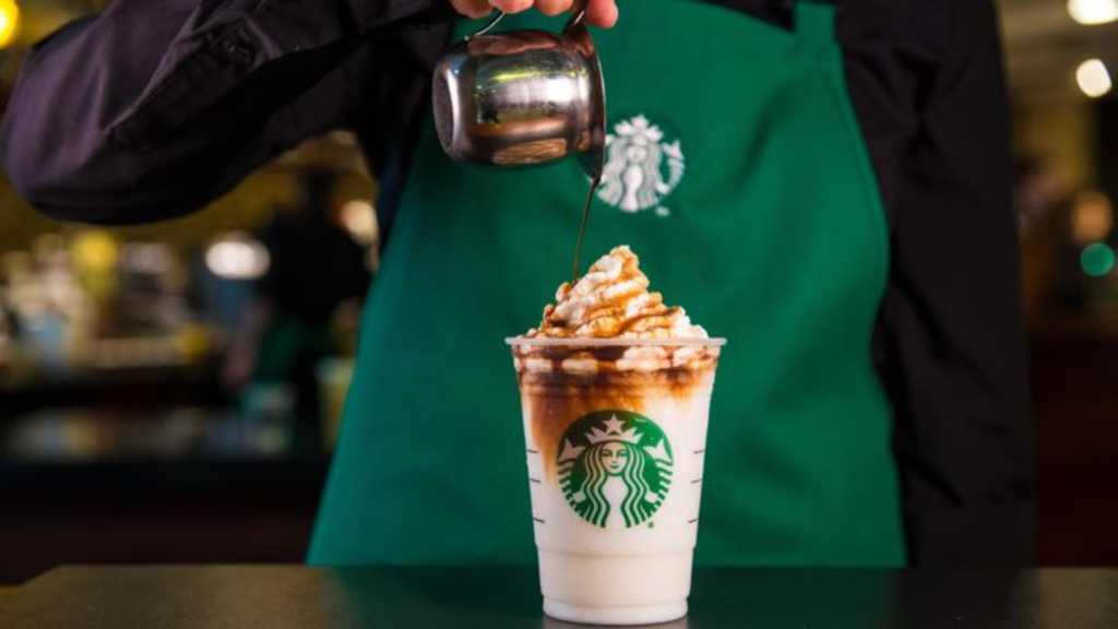 A barista customizing coffee