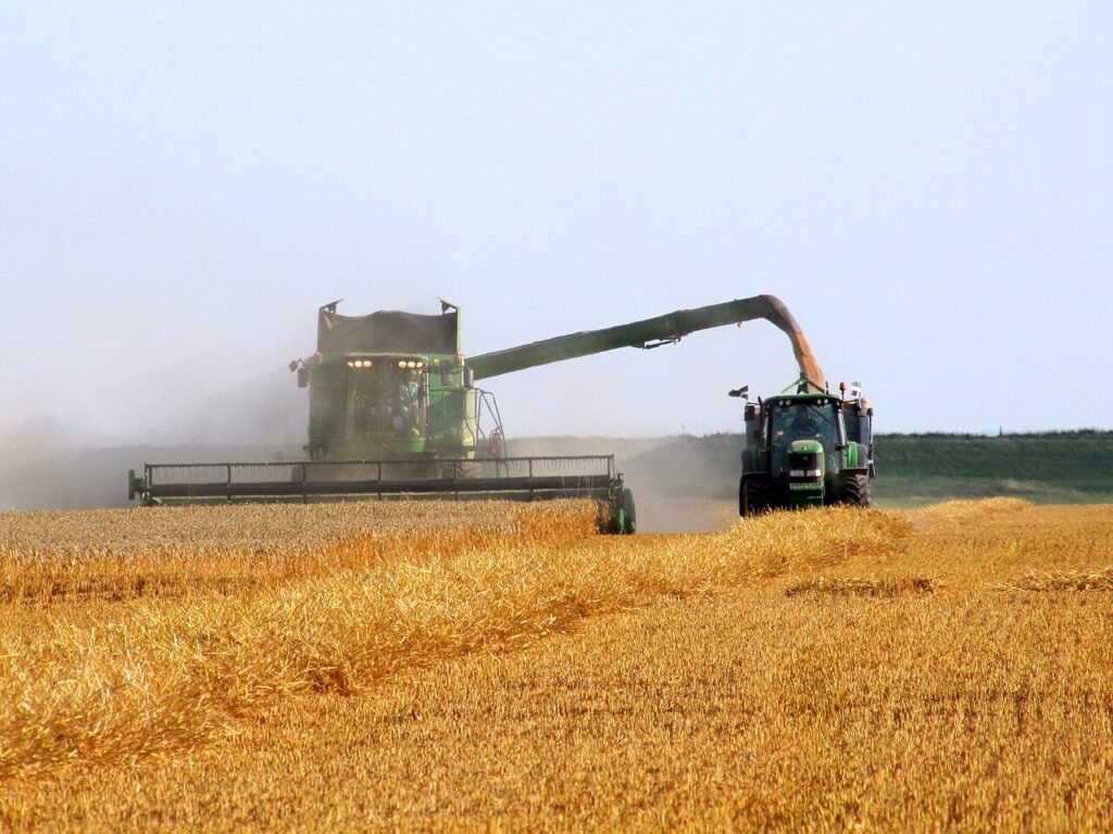 John Deere combine and tractor at work