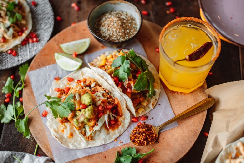 Tacos on a Cutting Board, Juice in Glass and Spices