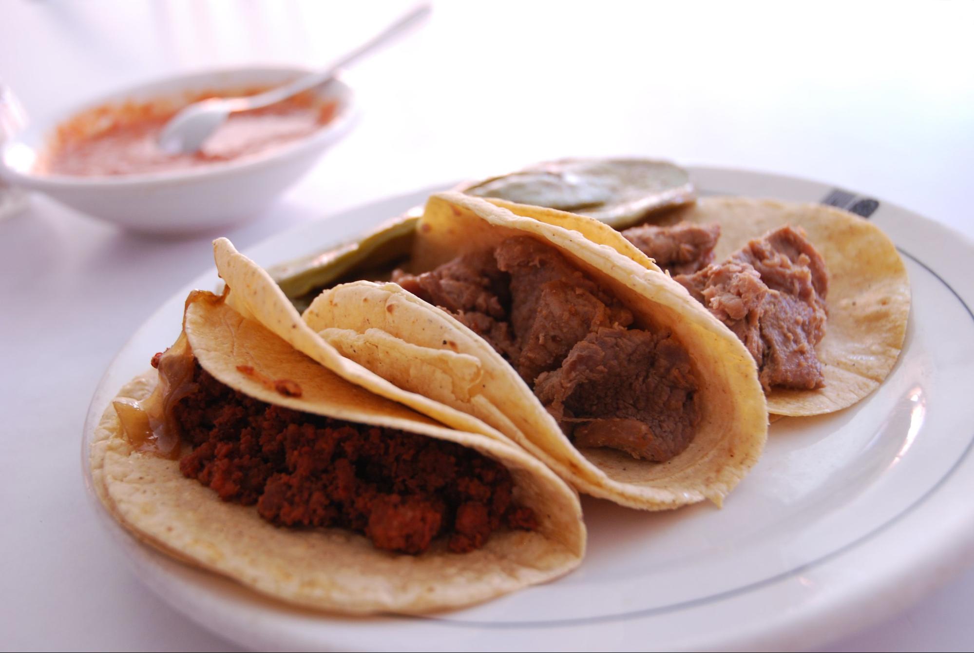 Tacos, a Mexican dish made with maize tortillas