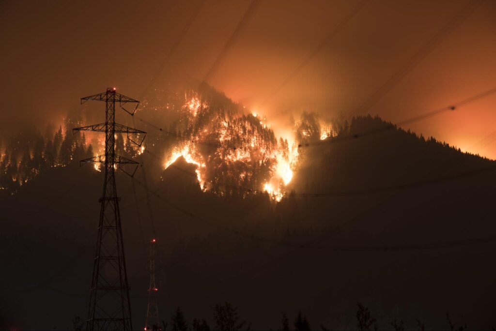 Transmission lines caving under the heat of a wildfire