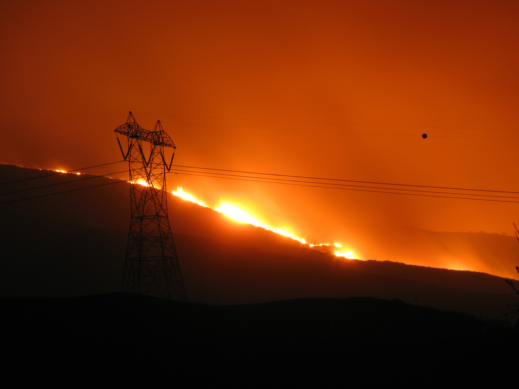 Fire raging close to the power transmission line