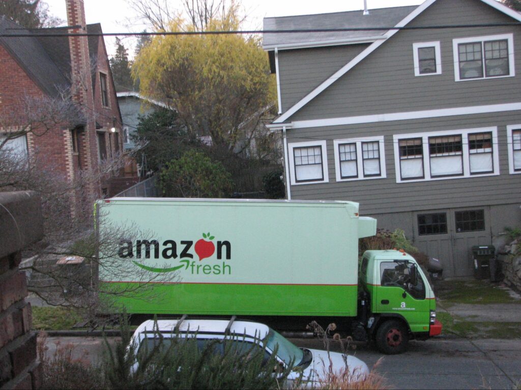 An Amazon Fresh truck driving through a neighbourhood