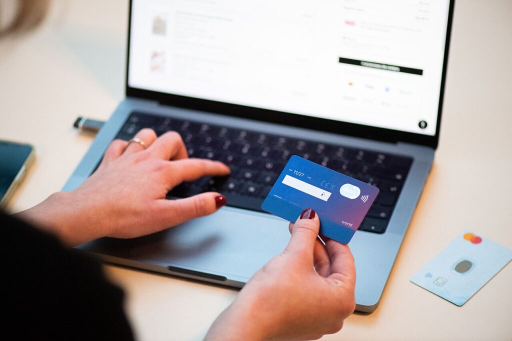 A person using a bank card to shop online