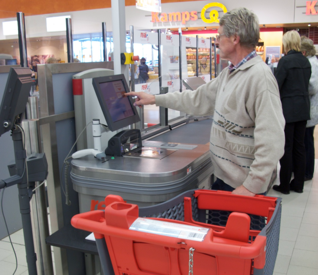 Man operating self-checkout machine