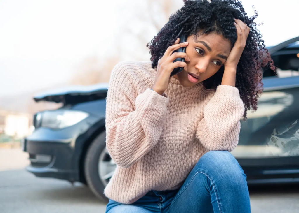 A lady making a call after a crash