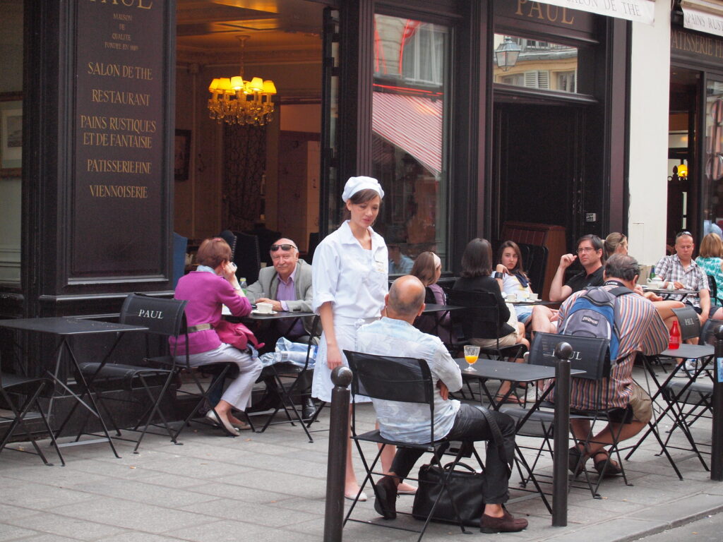 Waitress in white in a cafe in Paris, France